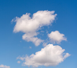Blue sky with white fluffy clouds, abstract natural background