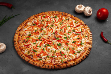 Pizza margarita with pumpkin seeds and feta on a concrete table near mushrooms and peppers.