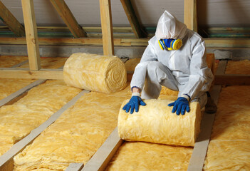 Construction worker thermally insulating house