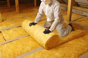 Construction worker thermally insulating house