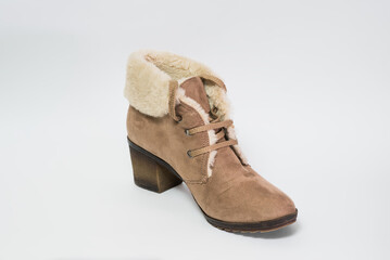 Low winter women's shoe of beige color with fur isolated on a white background.