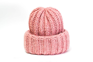 Fototapeta na wymiar Knitted from wool winter women's hat of pink color isolated on a white background.