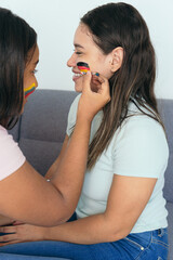 Woman painting German flag on a friend's face