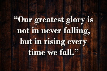 “Our greatest glory is not in never falling, but in rising every time we fall.”  Inspirational quote on vintage retro background. Ancient Chinese philosopher Confucius quote.