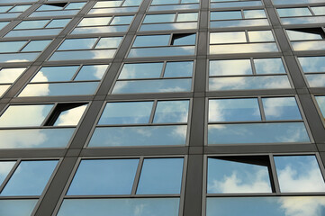 cloudy sky reflection on glass surface of modern building