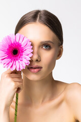 Fototapeta premium Beauty face of young woman with flower. Beauty treatment concept.