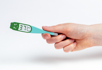 Woman hand with thermometer model showing 37. Body temperature measurement. Health care, control over wellbeing concept. High quality photo