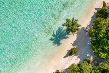 Maldives aerial island landscape. Tropical beach coast from drone. Exotic nature, palm trees over white sand close to coral reef, blue sea, lagoon. Summer and travel vacation concept. Beautiful nature