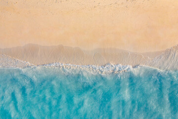 Summer seascape beautiful waves, blue sea water in sunny day. Top view from drone. Sea aerial view, amazing tropical nature background. Beautiful bright sea with waves splashing and beach sand concept © icemanphotos