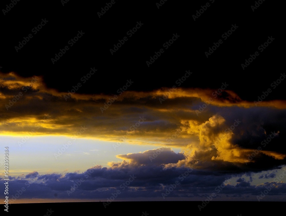 Wall mural colored clouds at sunset