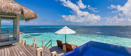 Beautiful panoramic travel sea landscape, luxury romantic beach holidays for honeymoon couple, tropical vacation in luxurious hotel resort. Amazing water villa with chairs and umbrella, infinity pool