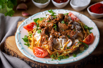 Turkish food; Cokertme Kebab - Beef meat kebab with yoghurt and french fries