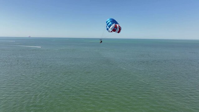 Aerial footage of a parachute over the sea