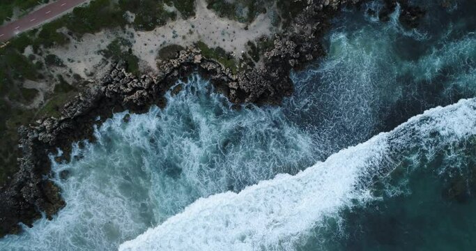 Aerial drone footage of the big ocean waves hitting rock