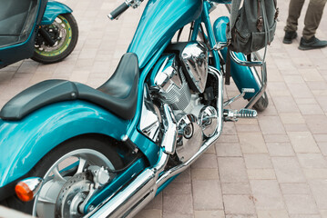 Stylish vintage motorcycle parked outdoors. Close-up of custom bike with shiny chrome details © Sergio