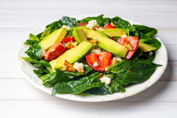 Healthy diet salad; Strawberry Spinach Salad with Avocado.