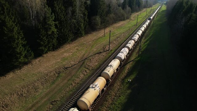 Freight Cars Deliver bulk Materials and gravel. Open Hoppers on railroad. Freight train with petroleum tank cars. Rail cars carry oil, crude and gas, ethanol. Railway logistics explosive cargo. 