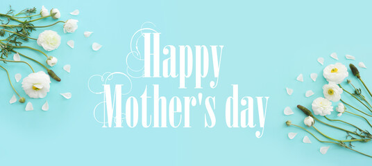 Fototapeta na wymiar mother's day concept with white flowers over blue pastel background