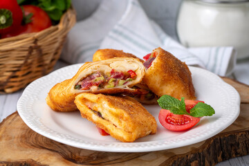 Turkish Pacanga Boregi with pastirma (pastrami) and cheddar (melted) cheese. - Pastirmali Borek