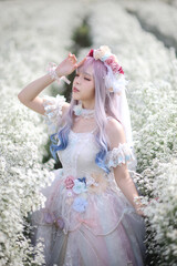 Beautiful young woman with white lolita dress with flowers garden Japanese fashion