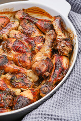 Hot homemade chicken with balsamic vinegar sauce in a baking dish. Shallow depth of field