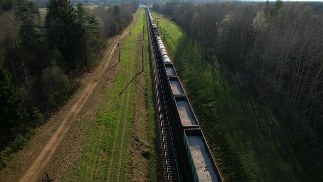 Freight Cars Deliver bulk Materials and gravel. Open Hoppers on railroad. Freight train with petroleum tank cars. Rail cars carry oil, crude and gas, ethanol. Railway logistics explosive cargo. 