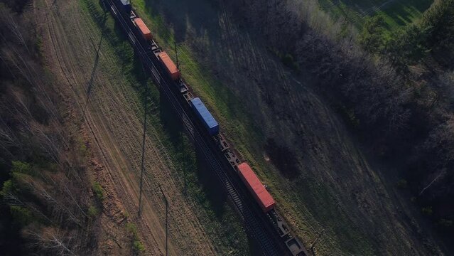 Shipping containers transportation on freight train by railway. Cargo Containers On Railroad. Intermodal Container On Train Car. Rail Freight Shipping Logistics. Multimodal Freight Transportation.