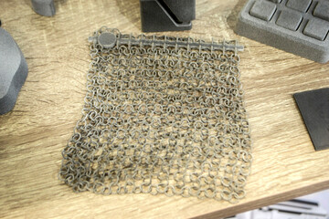 Many models gray printed on 3D printer. Gray objects printed on 3D printer made of plastic close-up. Many of 3D printed models. Prototypes of various shapes made by 3d printer. Symbol innovative