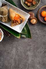 Fototapeta na wymiar Zongzi, rice dumpling for Dragon Boat Festival on dark gray table background with ingredient.
