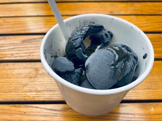 Close-up of bamboo charcoal ice cream cup- exotic food in Asia