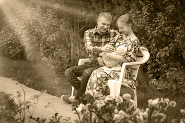 Family with a child in the park on a bench