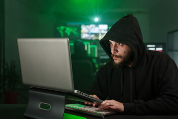 Hacker man typing on laptop, hacking computer system with virus