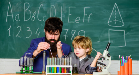 Imagination turns to innovation. Back to school. school kid scientist studying science. father and son at school. teacher man with little boy. Little kid learning chemistry in school laboratory