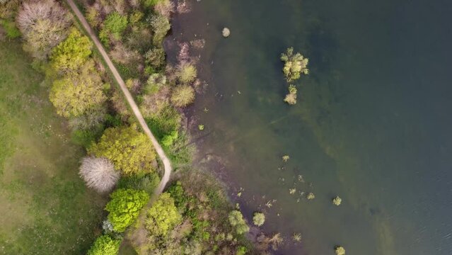 aerial shot of a lake in the green fields of the basque country