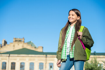 smiling kid with school bag outdoor with copy space. back to school