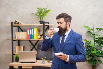 mature entrepreneur in jacket enjoy having coffee break at office, professional