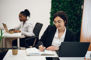 Fototapeta premium Business working on a laptop in a creative office environment