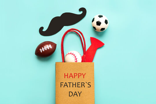 Happy Father's Day. Top view of shopping bag with false mustache,false bow tie and sports balls. Father's Day celebration concept