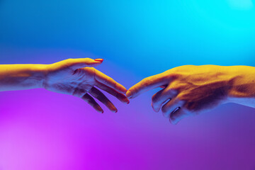 Two human hands touch each other isolated on gradient blue-purple background in neon light. Concept of human relation, togetherness, symbolism, culture and history - obrazy, fototapety, plakaty