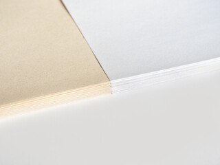 Paper without bleaching in comparison with ordinary white of high quality. White recycled paper background or texture. Import substitution. Flat lay, copy space.