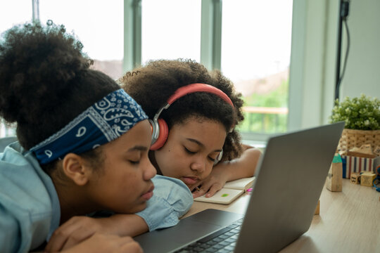 African American school children sleeping on desk at classroom,Girl is tired and sleeps.