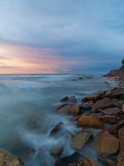 Sunrise view of rocky coastline with beautiful sky.