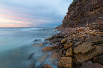 Fototapeta na wymiar Sunrise view of rocky coastline with beautiful sky.