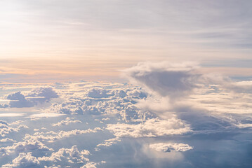 Fototapeta na wymiar View over the clouds above Tanzania. Bright skyscape