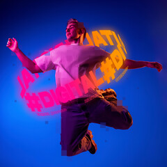 Contemporay artwork. Young man with neon lettering around body dancing isolated over blue...