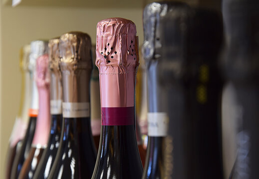 Sparkling wines from different countries are placed on the store shelf.

