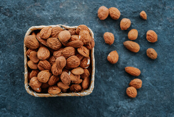 square palm basket full of shelled almonds