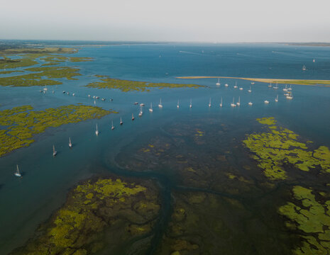 Aerial view of Keyhaven lake with anchored yachts, Lymington, United Kingdom.
