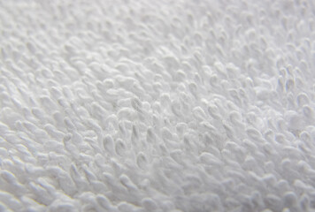 White natural cotton towel background. Texture of white terry towel close-up.