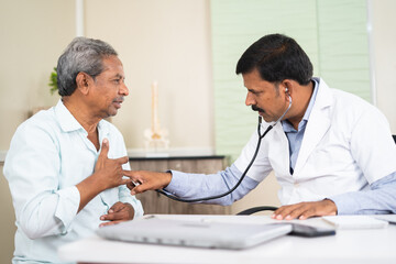 senior patient visitng doctor due to suffering chest pain at hospital - concept of health check up,...